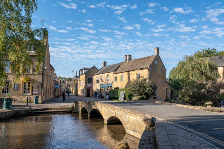 bourton on the water mill bridge and buildings on a sunny day, one of the best villages in the cotswolds to visit